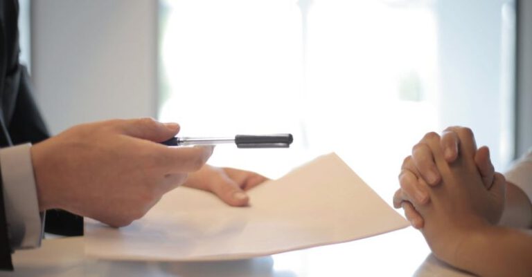 Proper Form - Crop businessman giving contract to woman to sign