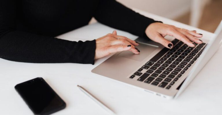 Prevention Plan - Crop faceless woman working on netbook in office