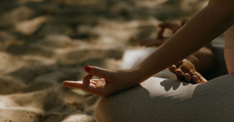 Yoga Poses - Close-up Shot of a Person Sitting on a Yoga Mat while Meditating