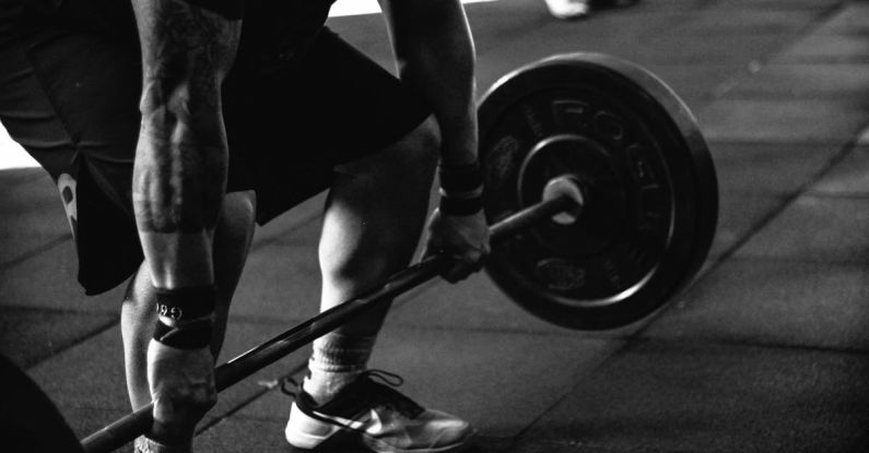 Lifting Weights - Man Carrying Barbel