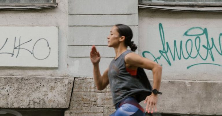 Cardio Workouts - A Side View of a Woman Jogging on the Street