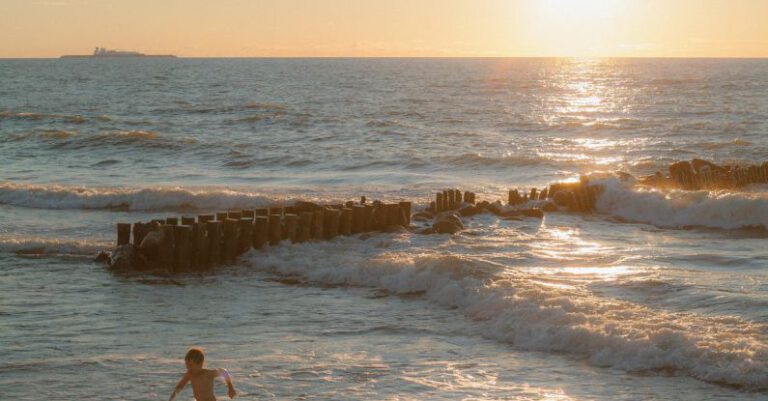 Running Plan - A person walking on the beach at sunset