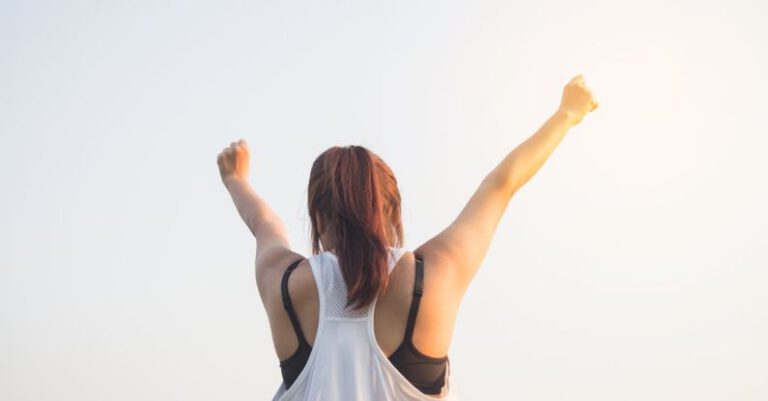 Motivated - Woman Wearing Black Bra and White Tank Top Raising Both Hands on Top