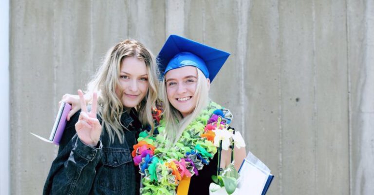 Milestones - Woman Wearing Blue Mortarboard Cap Standing Near Woman Wearing Blue Jacket