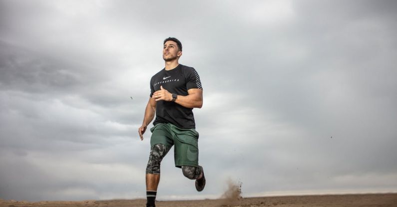 Workout - Man Running on Sand Field